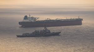 A US Navy destroyer stops an Iranian-flagged ship and enforces a port blockade in Iran.